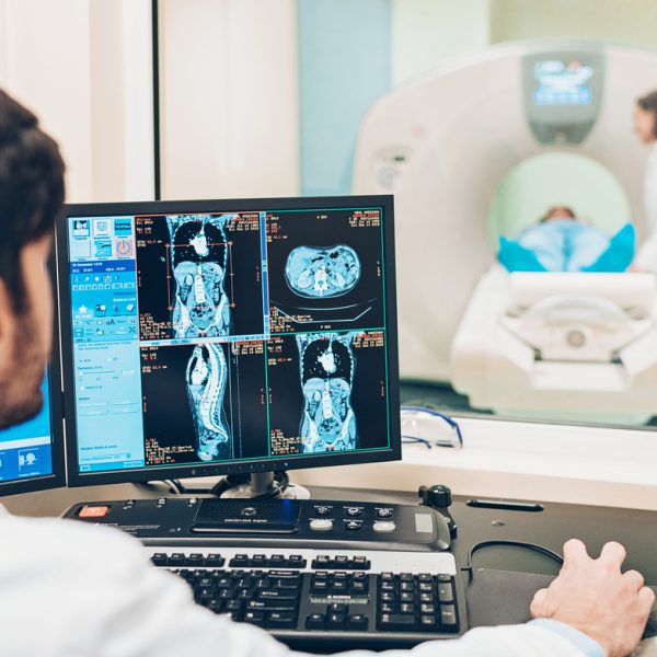 Doctor looking at a monitor with patient's MRI scan results